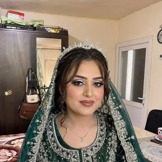 Bride in an emerald and gold embroidered dupatta with a tiara, by Sadaf Bridal