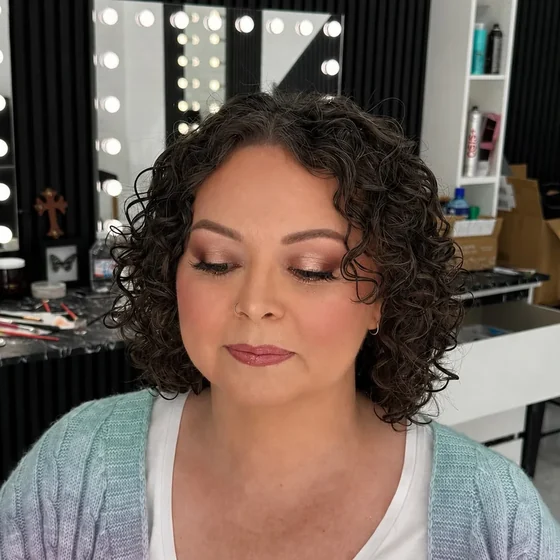Soft glam makeup on short dark curls, warm eye and rose lip, by Sadaf Bridal