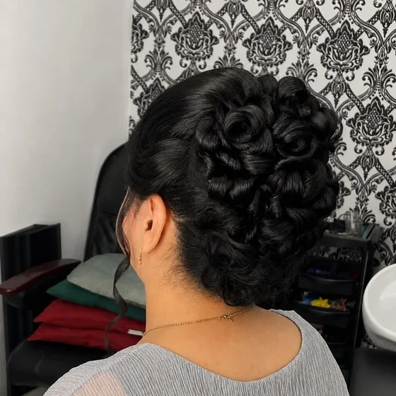 Curled bridal updo, dark hair pinned into soft loops, by Sadaf Bridal